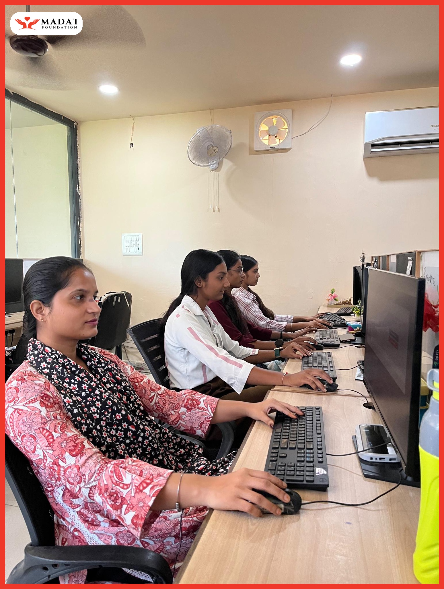 Girls participating in computer skills training at MADAT Foundation